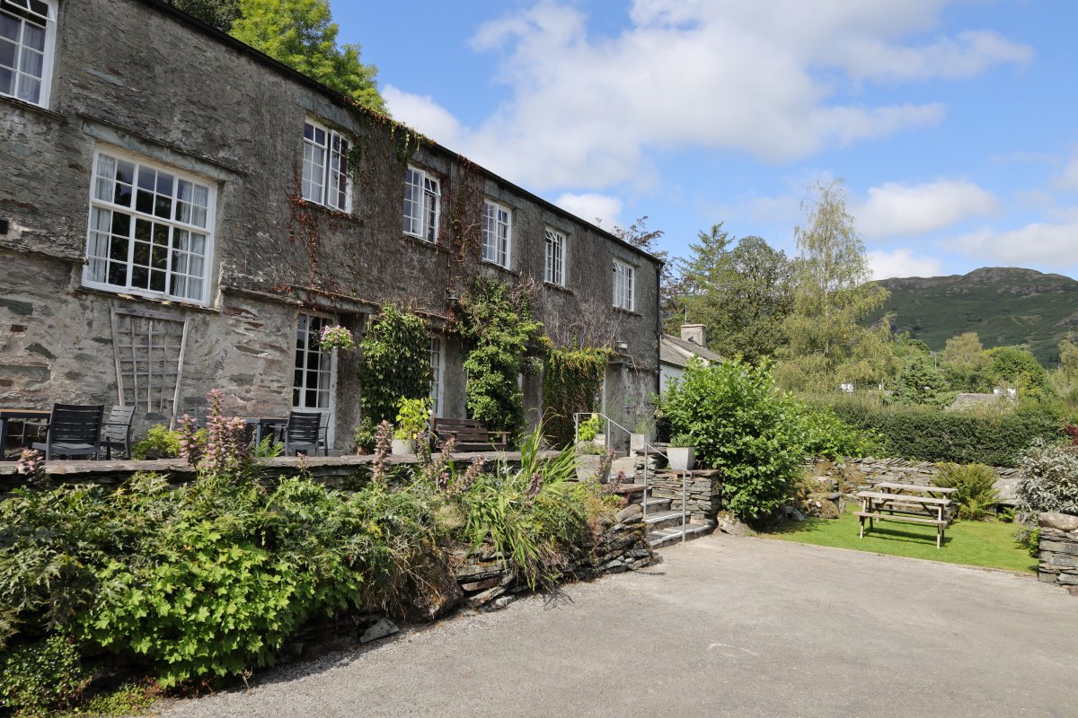 Frontage of Elterwater Hostel with view to Loughrigg